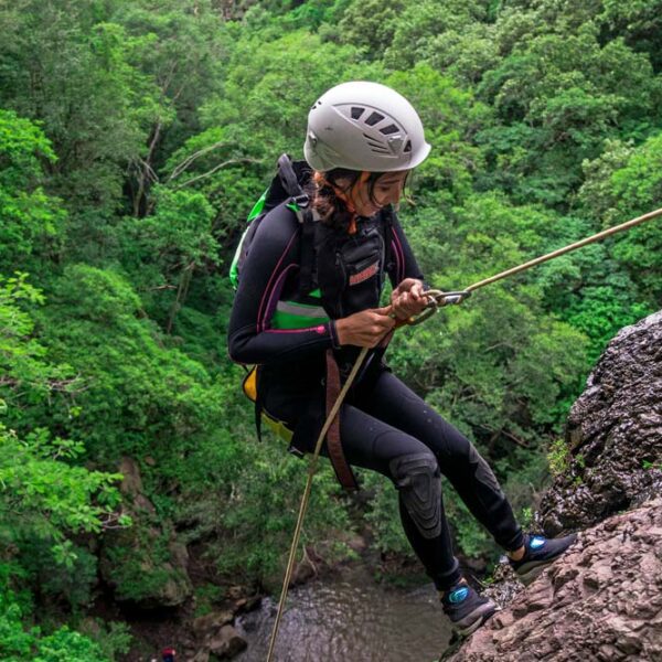 Woman abseiling on cliff edge