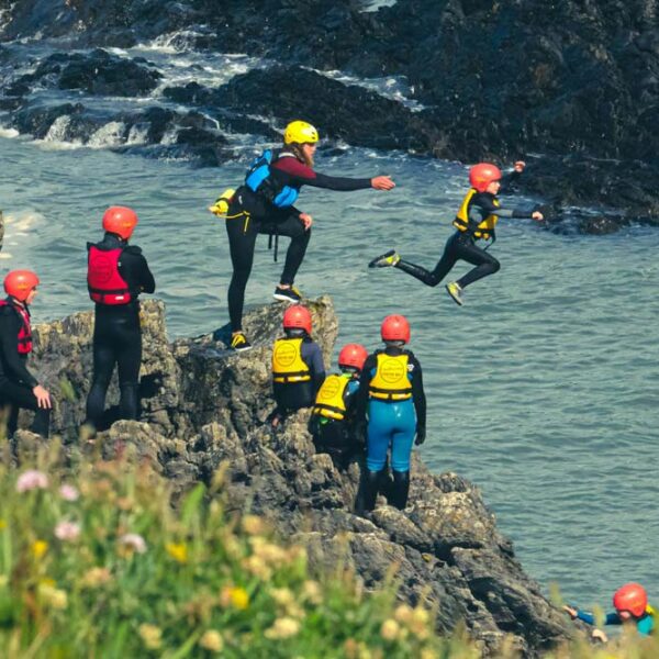 Group jumping into the sea from rocks