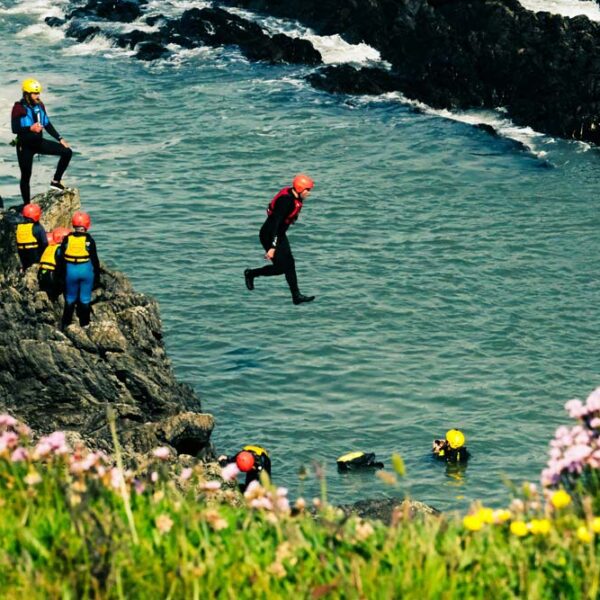 Group jumping into the sea from rocks