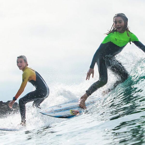 Two teenage girls surfing in County Donegal